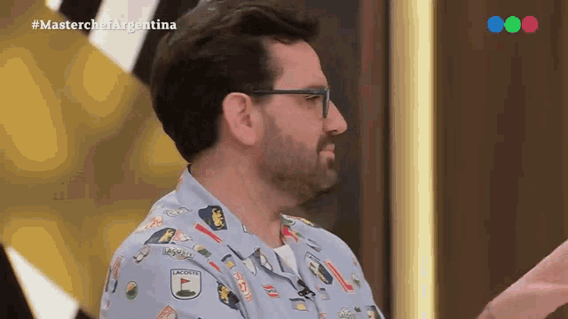a man wearing a shirt that says lacoste is on a television show