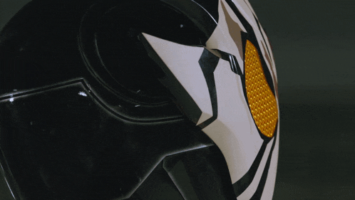 a close up of a motorcycle helmet with a yellow lens