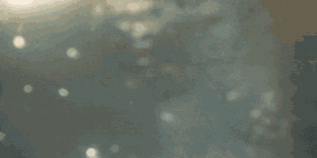 a blurred image of a person swimming in the ocean