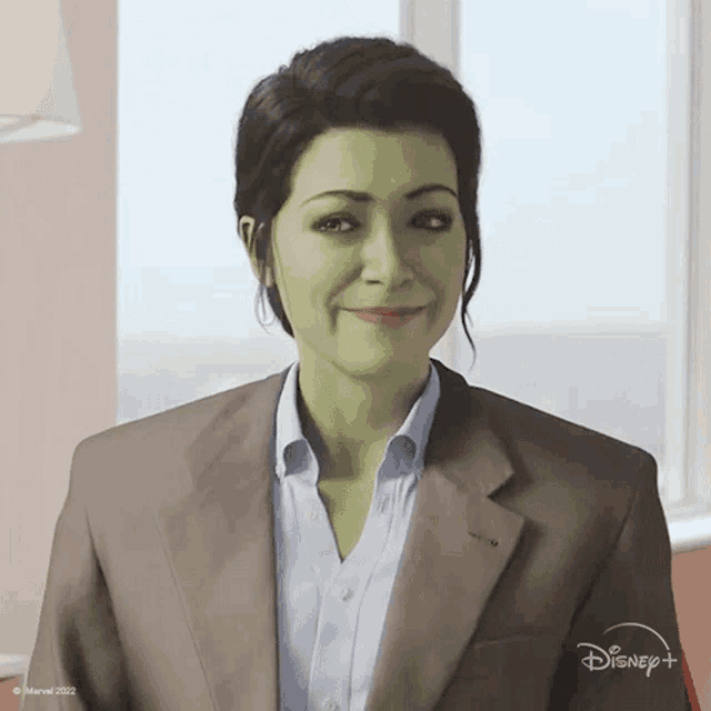 a woman with green hair is wearing a suit and smiling for the camera