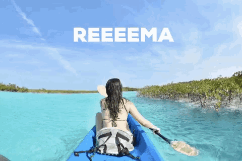 a woman in a bikini is paddling a blue kayak with the word reeeema behind her