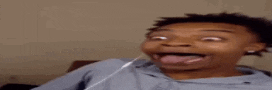 a young man is making a funny face while wearing headphones .