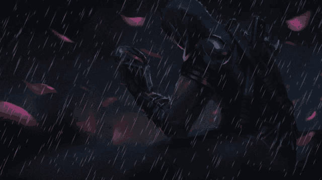 a person standing in the rain with pink petals falling from the sky
