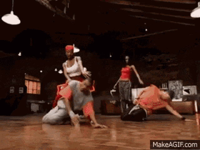 a group of people are dancing on a dance floor with the website makeagif.com visible in the corner