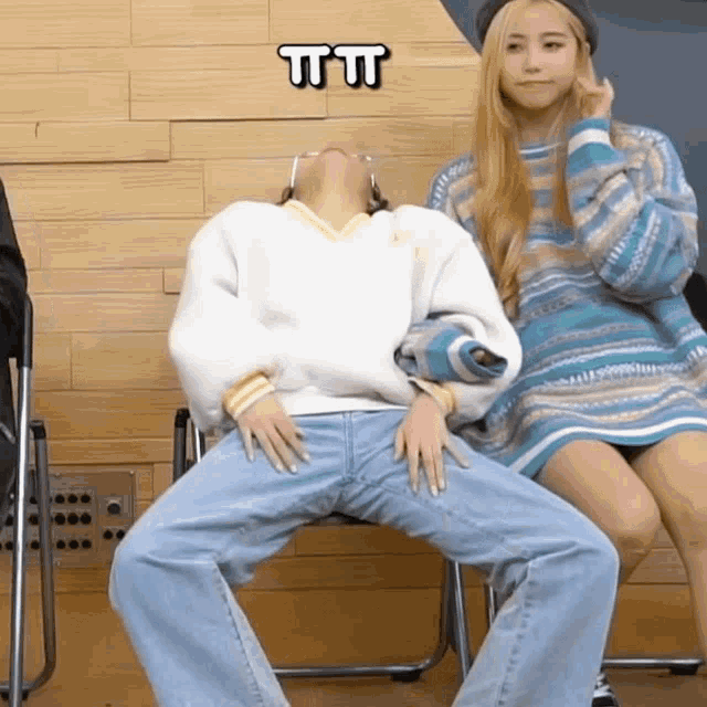 a woman sitting next to a man with the letters ttt written on the bottom