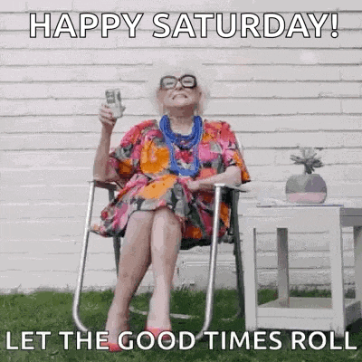 an elderly woman is sitting in a folding chair holding a glass of beer .