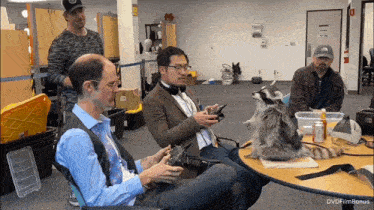 a raccoon sits on a table with a group of people