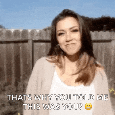 a woman is standing in front of a wooden fence and asking why you told me this was you