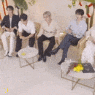 a group of people are sitting in chairs in a room