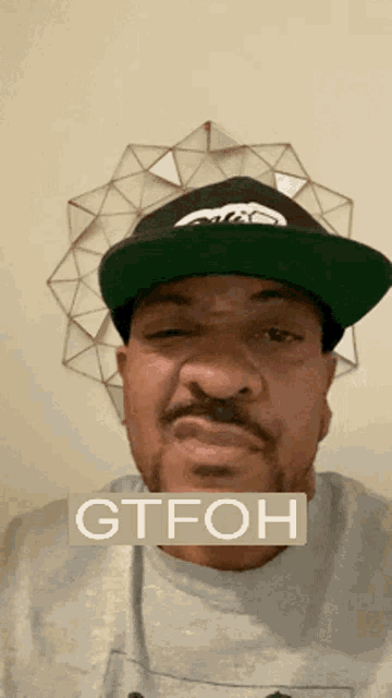 a man wearing a hat with the word gtfoh on the bottom right
