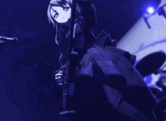 a person playing a guitar and singing into a microphone on a stage