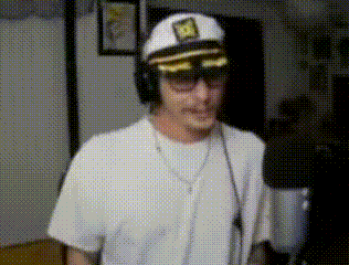 a man wearing a captain 's hat and sunglasses