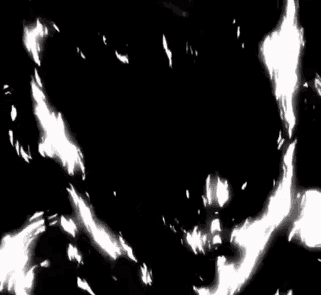 a black and white image of a monster with glowing eyes .