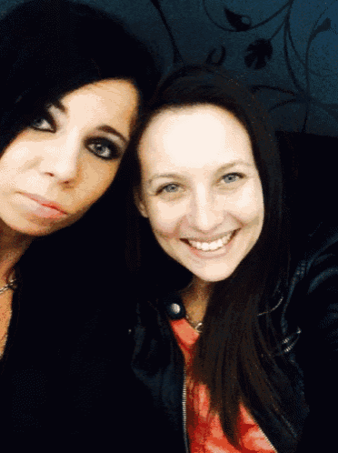 two women are posing for a picture and smiling