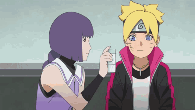 a girl is giving a boy a glass of water
