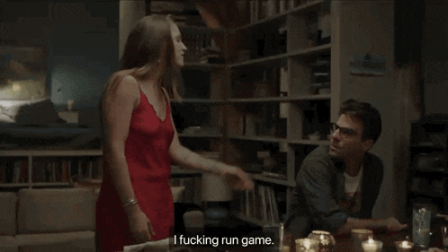 a woman in a red dress says " i fucking run game " in front of a man