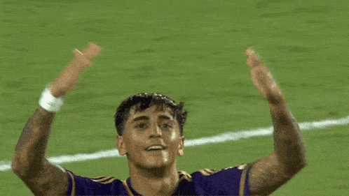 a soccer player wearing a purple orlando health shirt