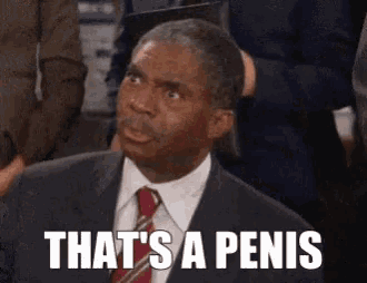 a man in a suit and tie with the words that 's a penis below him