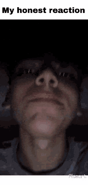 a close up of a man 's face with the words `` my honest reaction '' written on the bottom .