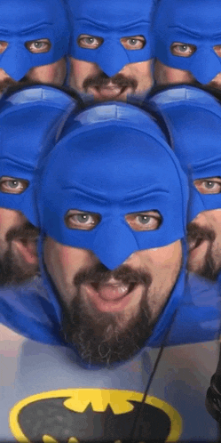 a man with a beard is wearing a batman costume