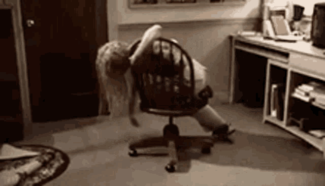 a woman is sitting in a chair in a room