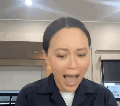 a woman in a police uniform is making a funny face with her tongue hanging out .