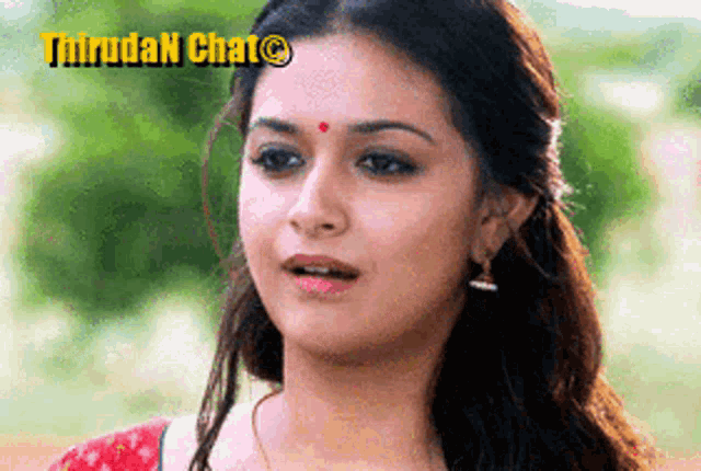 a close up of a woman 's face with a red dot on her forehead and the words thiruda n chat above her