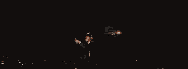 a man wearing a black jacket and a hat with the word la on it