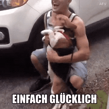 a man is kneeling down holding a dog with the words einfach glücklich below him