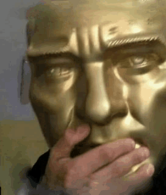 a close up of a statue of a man with his hand on his mouth .