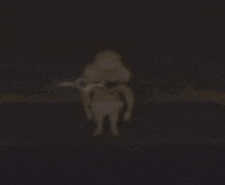 a blurred image of a person holding a sword in the dark