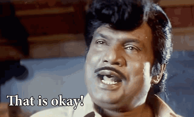 a man with a mustache says that is okay with his mouth open