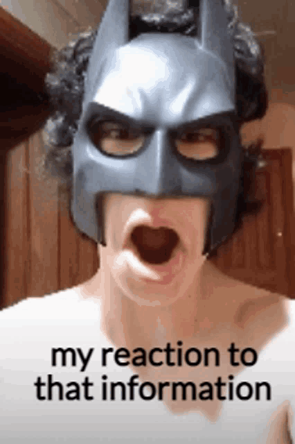 a man wearing a batman mask has his mouth open