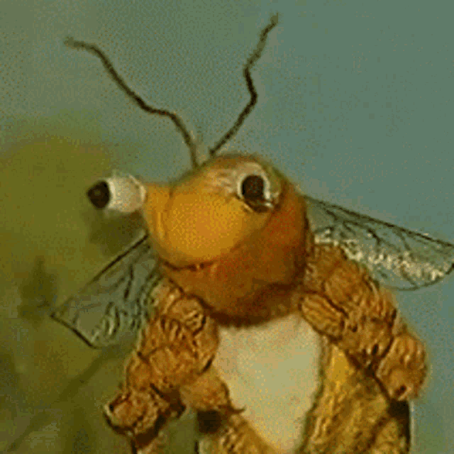 a close up of a stuffed animal that looks like a bee with its mouth open