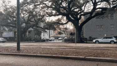 a white suv is parked on the side of a street