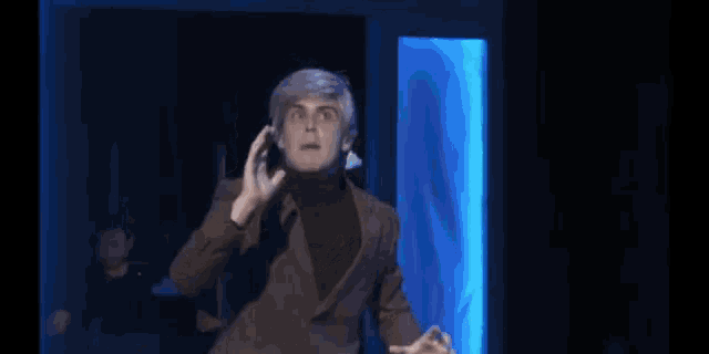 a man in a brown suit is screaming with the words come on you bastard behind him