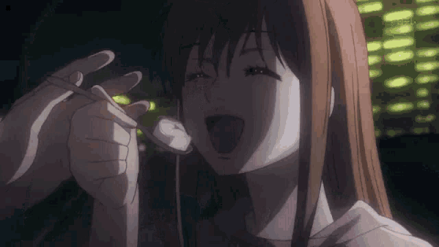 a girl in a pink shirt is eating something with chopsticks .