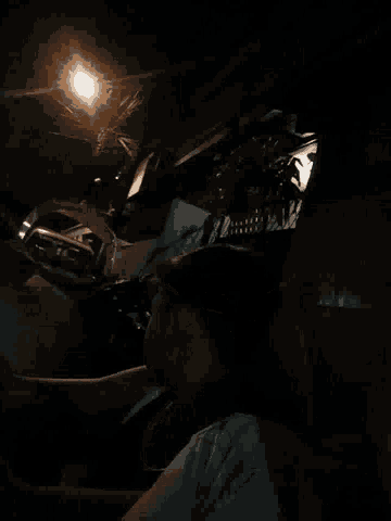 a man is laying down in the dark with a light behind him