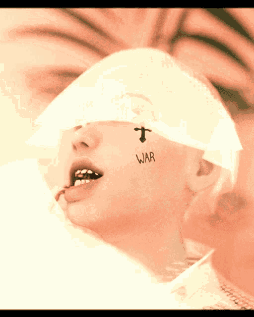 a person with a tattoo on their face that says " war "