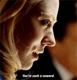 a woman is saying you 're such a coward