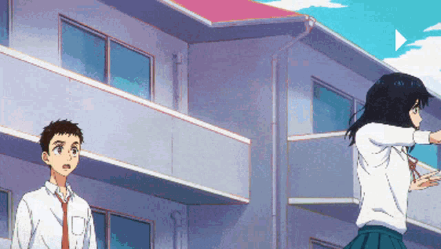 a boy and a girl are standing outside of a building