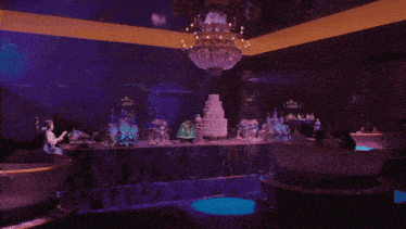 a woman sits in a bathtub in front of a table with a cake on it