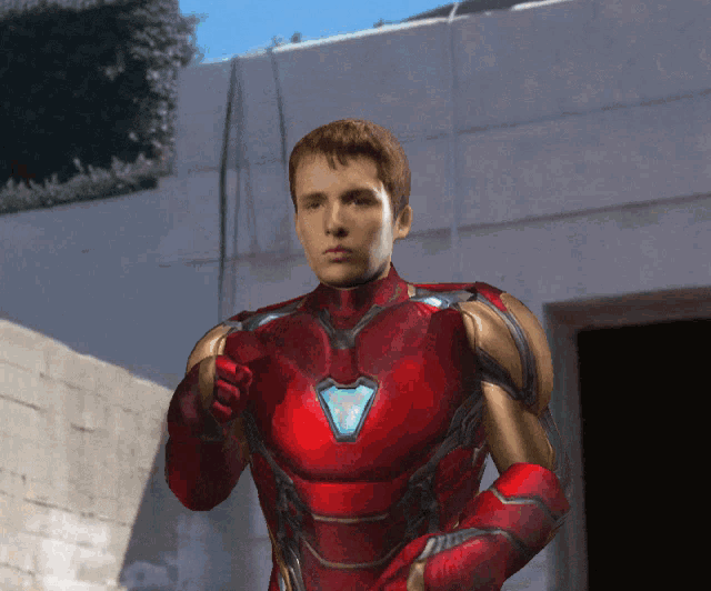 a young man in a red and gold iron man suit