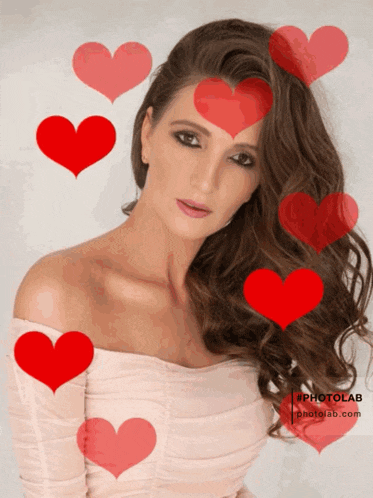 a woman is surrounded by red hearts and the website photolab.com is in the corner