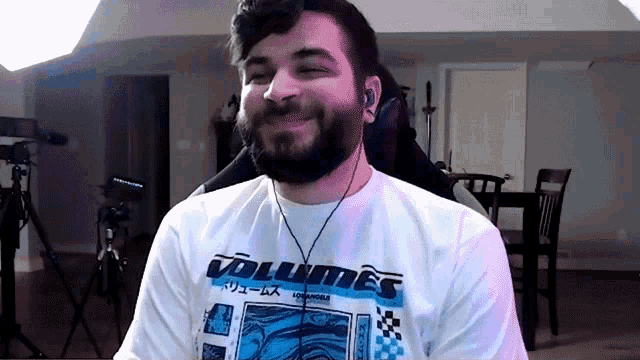 a man wearing a white shirt that says volumes