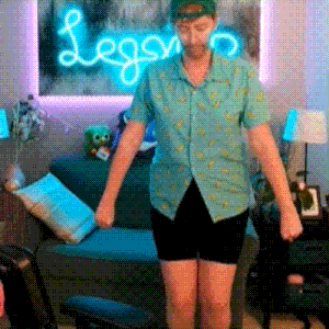 a man is standing in front of a neon sign that says legro