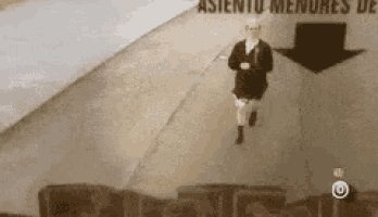 a man in a suit and tie is running down a street with an arrow pointing down ..