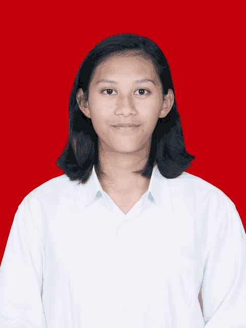 a young woman in a white shirt is standing in front of a red background