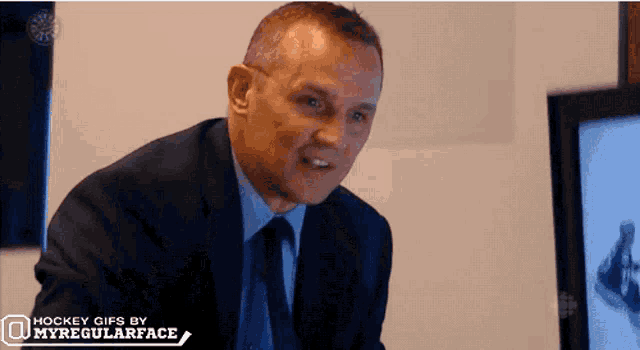 a man in a suit and tie is shown in a hockey gif by myregularface