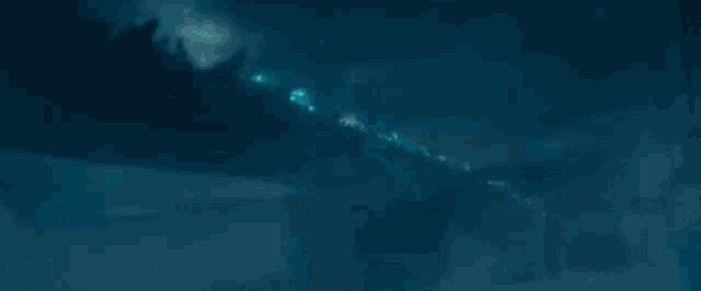 a close up of a monster in the water with smoke coming out of it .